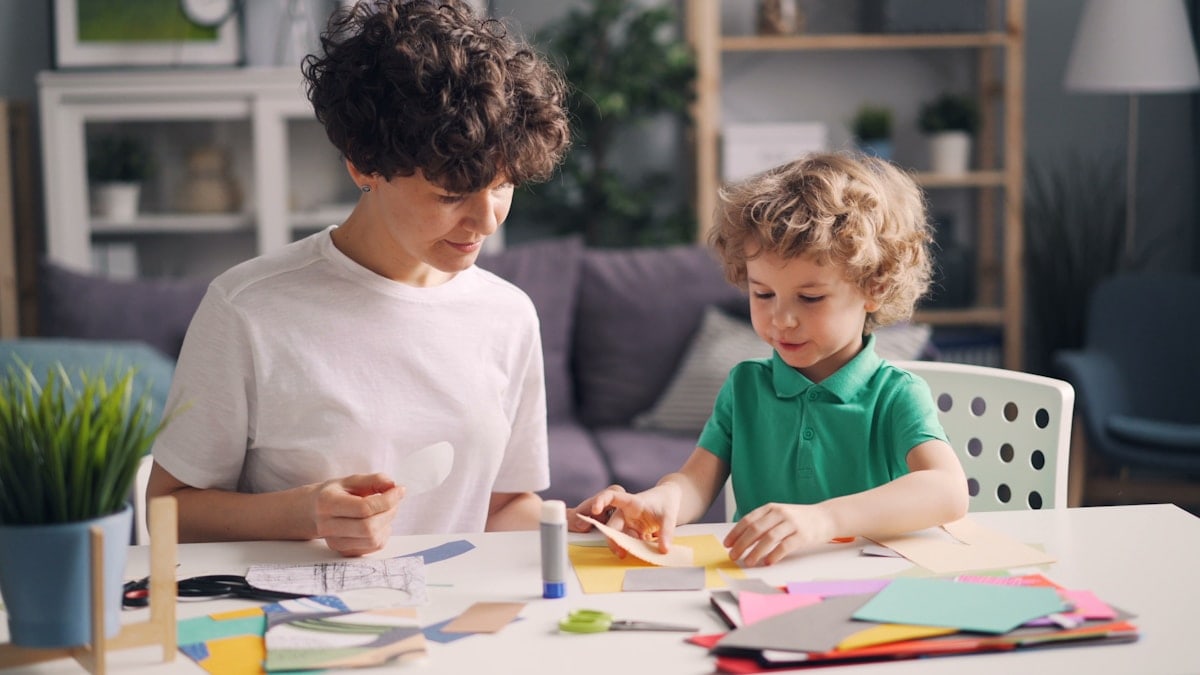 a woman and a child are sitting at a table